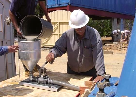 Kenrich grout pump used in stabilizing mounting plates